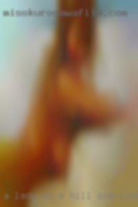 A lady on a hill overlooking that girls a city.